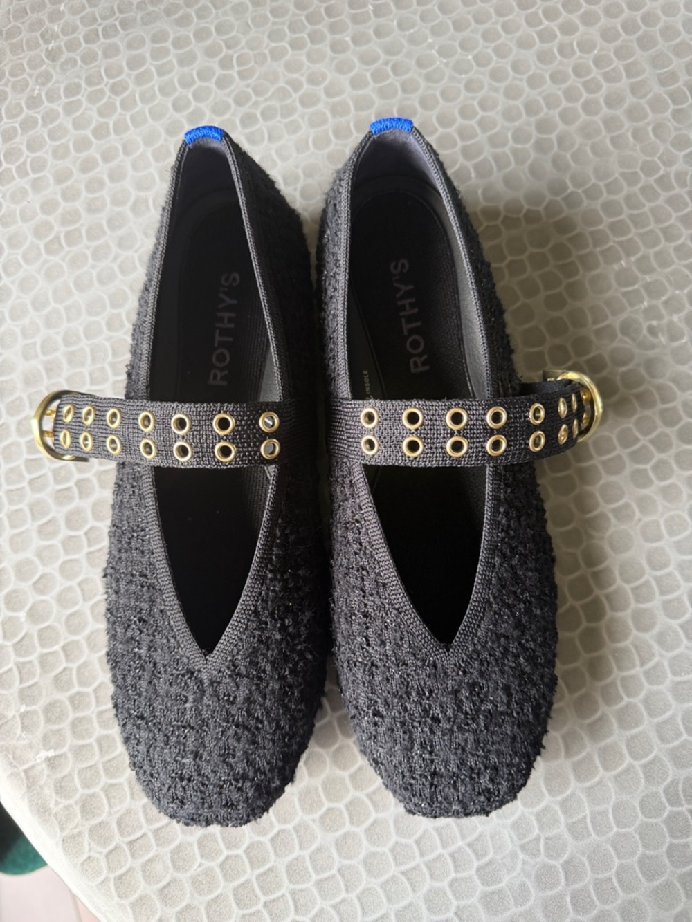 Rothy's Black Mary Jane Flats with Gold Eyelet Strap and Blue Heel Tabs